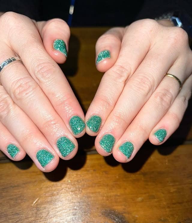 1. Emerald Frost Sparkle - short christmas nail ideas