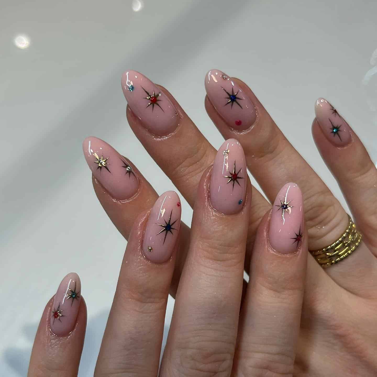 13. Starry Christmas Glow - short christmas nail ideas