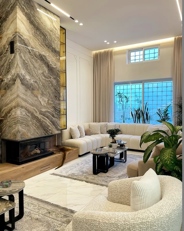 2. Contemporary Elegance with Marble Drama - fireplace living room ideas