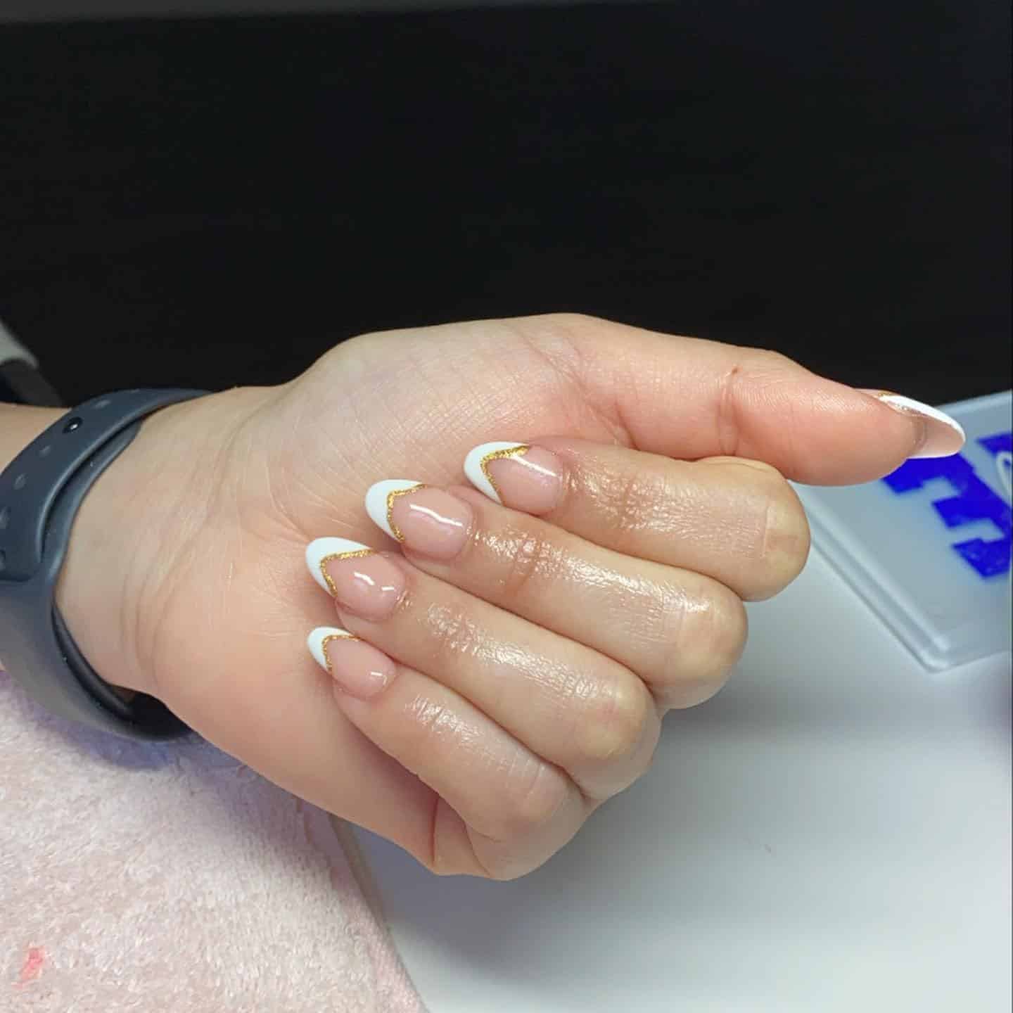 8. Golden Tipped French with White Edge - short rounded nail ideas