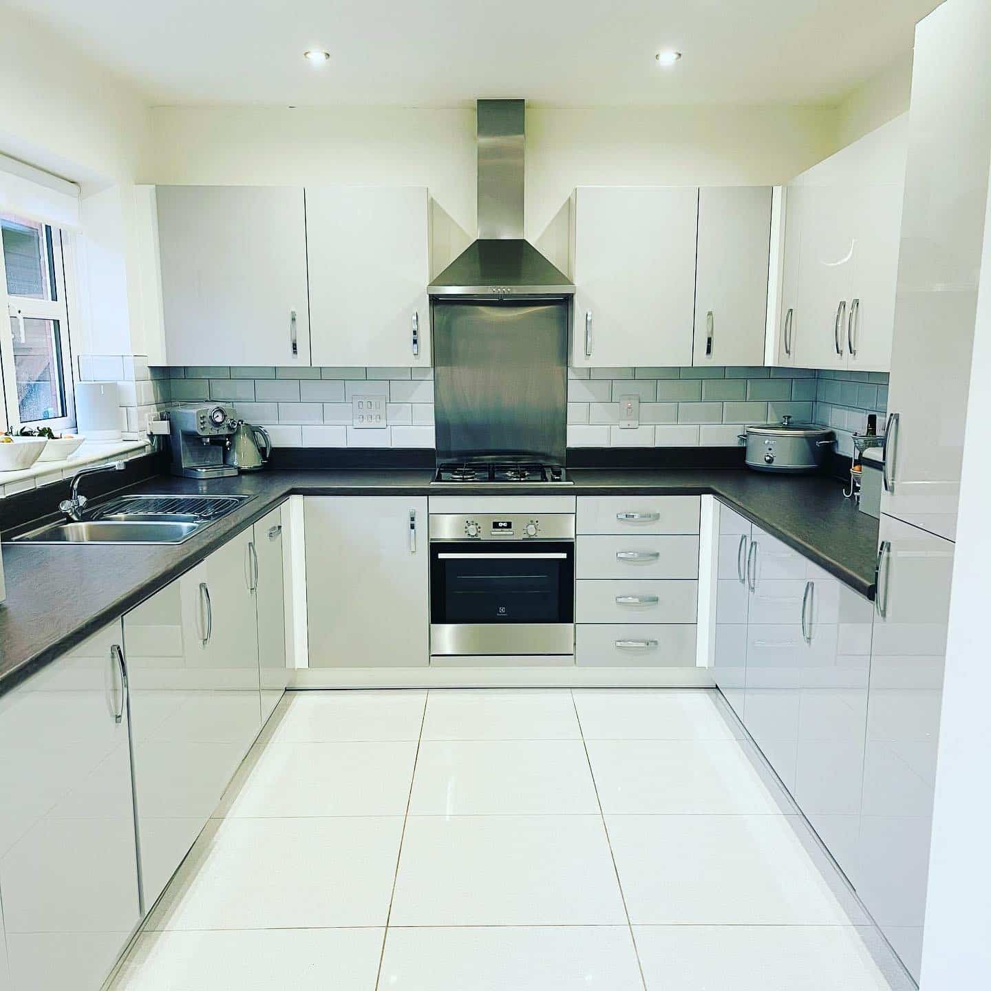 12. Contemporary Gloss with Subtle Contrast - white kitchen floor ideas