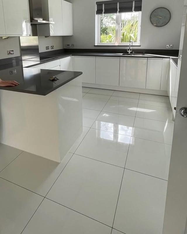 18. Glossy White with Graphite Balance - white kitchen floor ideas