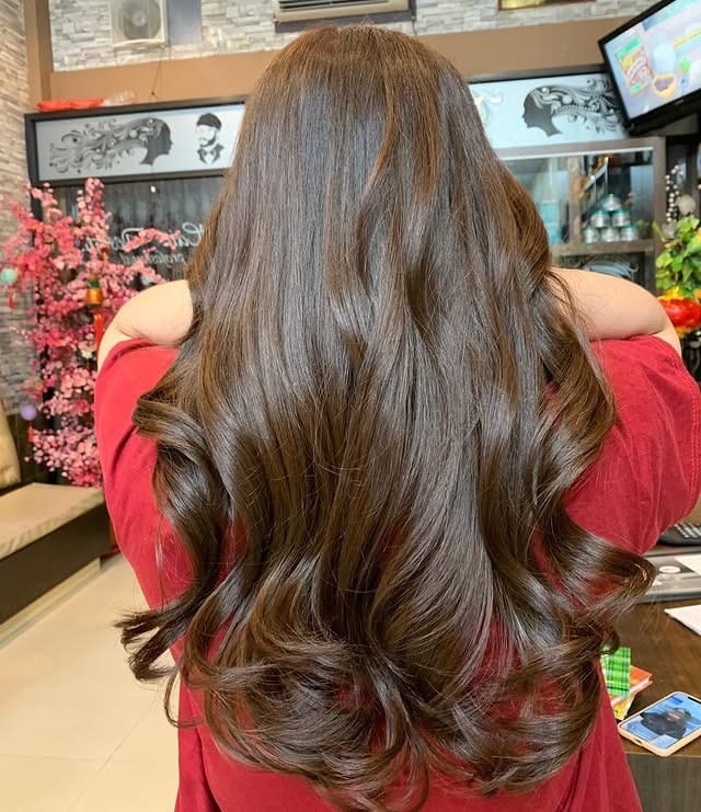 9. Deep Chocolate Brown with Voluminous Curls - Medium Brown Hair Color