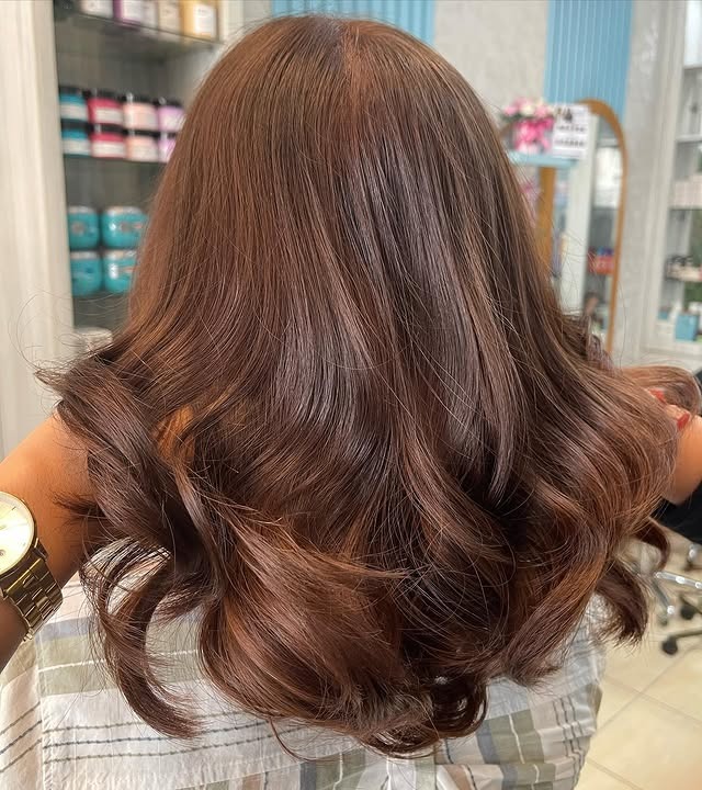 17. Caramel-Tinted Medium Brown Curls - Medium Brown Hair Color