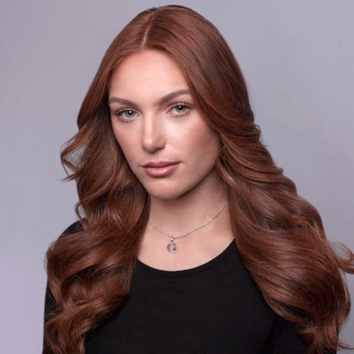 14. Polished Chestnut Elegance with Flowing Curls - Chestnut Hair Color