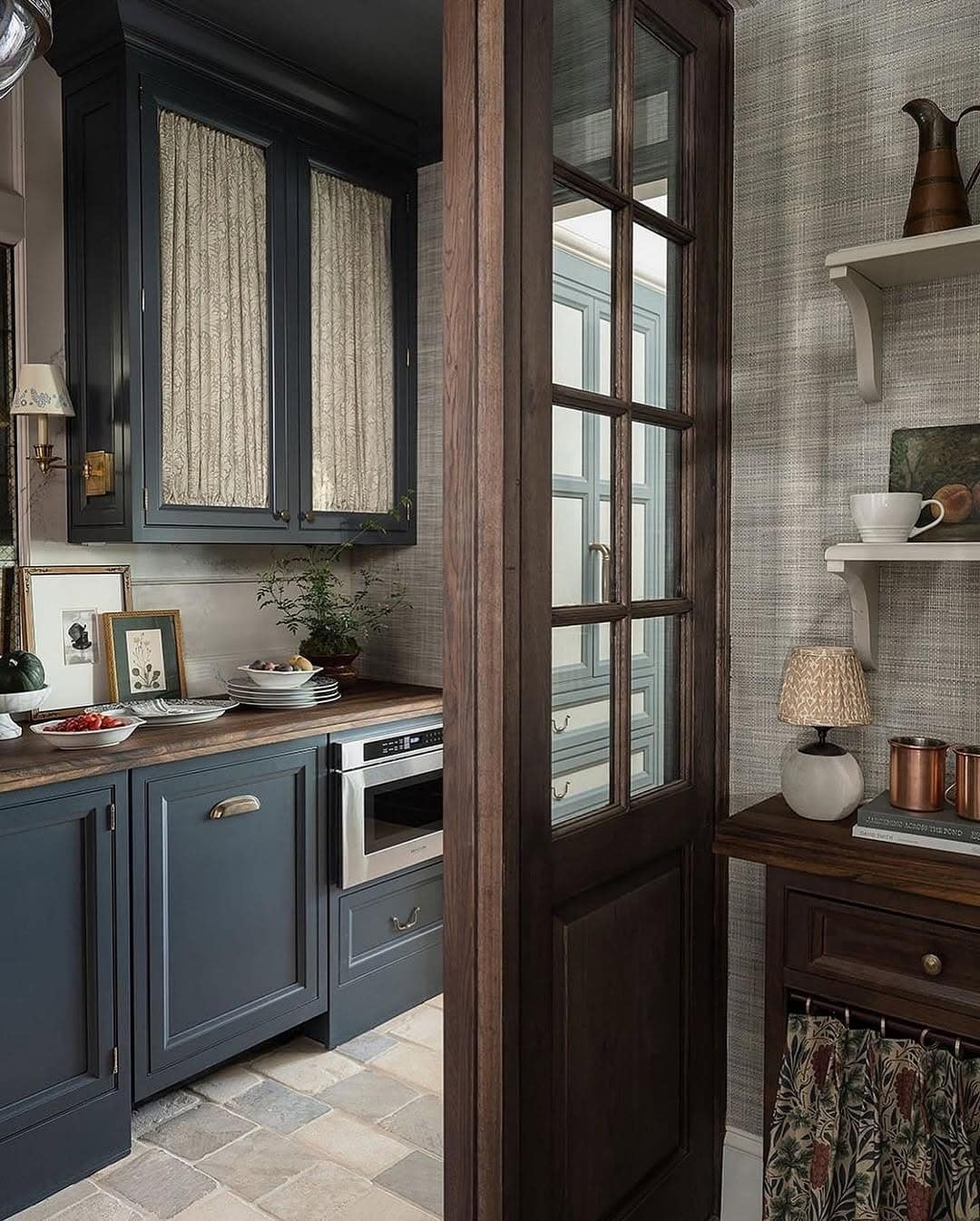 7. Classic Charcoal Kitchen with Wood-Framed Door - kitchen and living room divider ideas