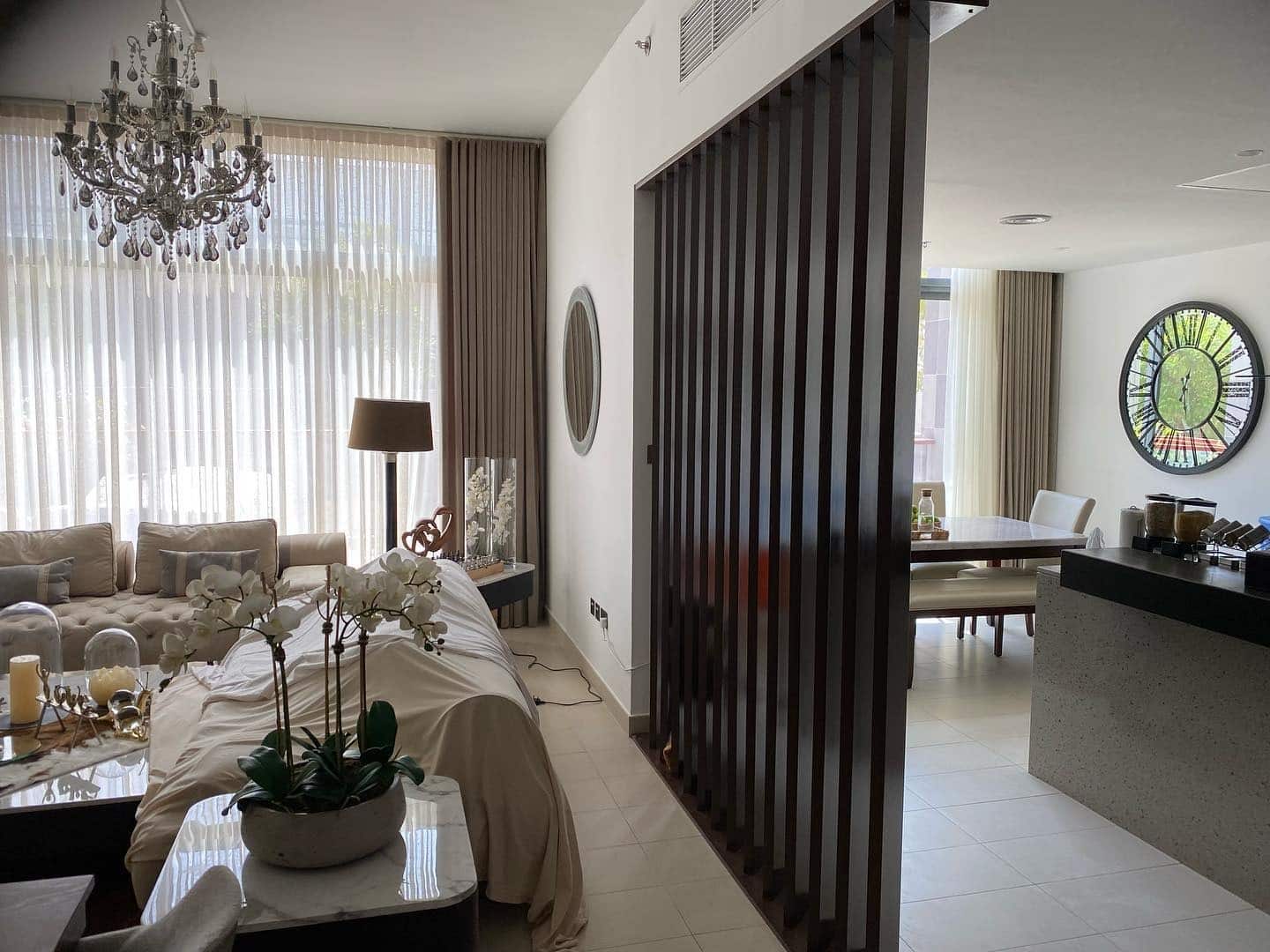 19. Dark Slatted Partition with Classic Accents - kitchen and living room divider ideas