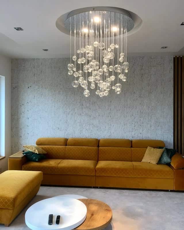 6. Amber Glow in a Modern Setting - living room chandelier ideas