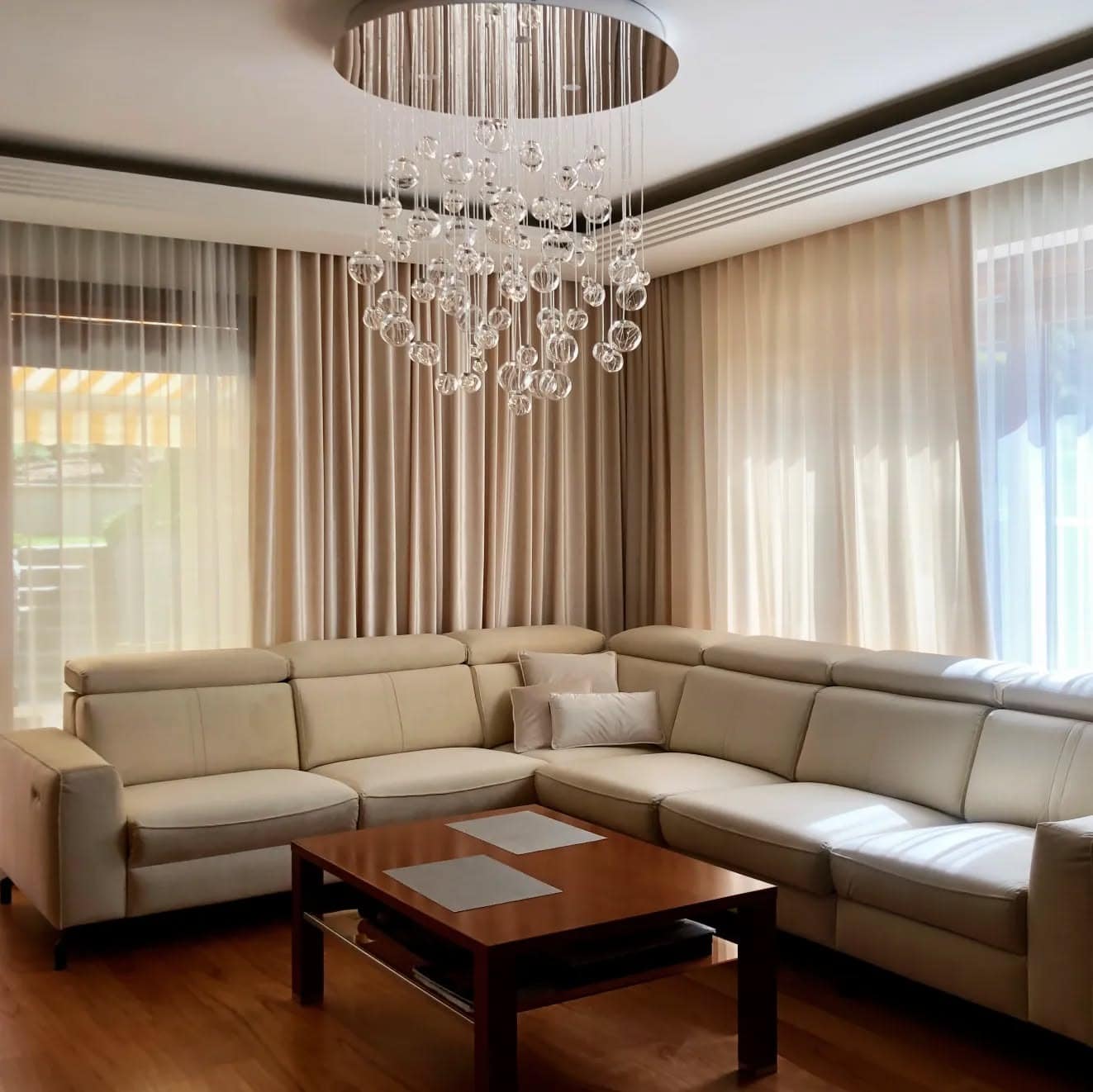 8. Soft Minimalism with Floating Sparkle - living room chandelier ideas