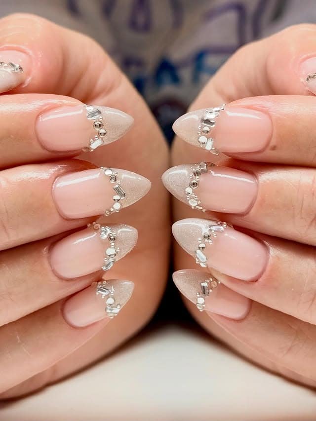 5. Shimmering Almond Tips with Silver Crystal Curve - simple diamond nail ideas