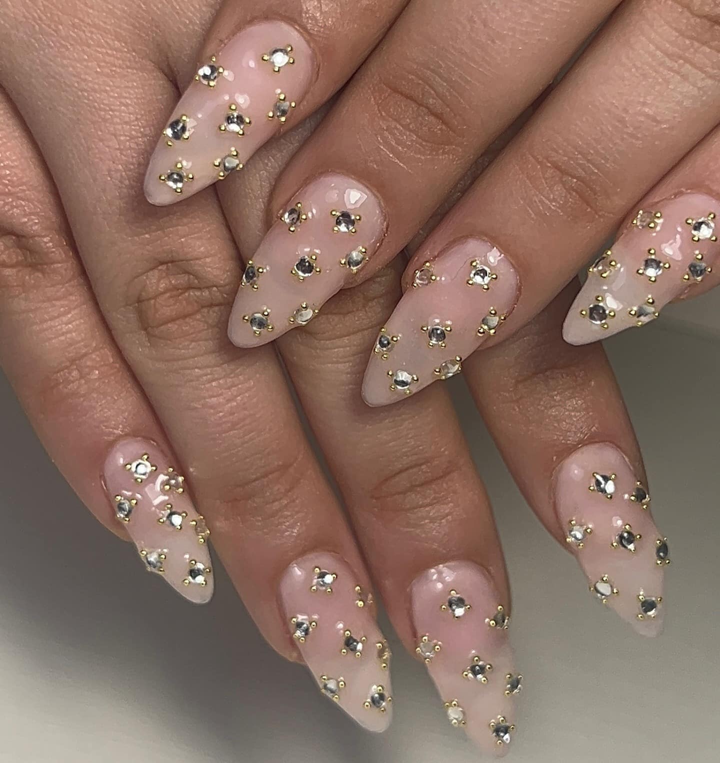7. Gold-Trimmed Diamond Studded Nude Nails - simple diamond nail ideas