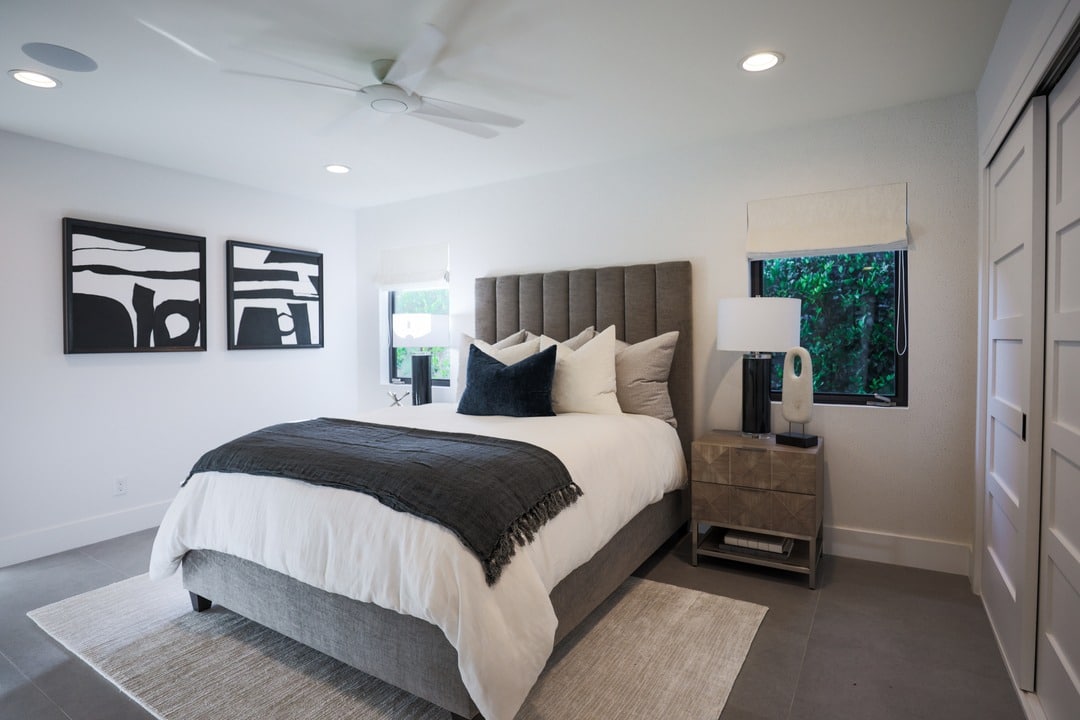 14. Crisp White and Charcoal Contrast with Graphic Art - grayscale bedroom ideas