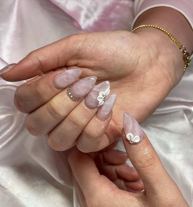 3. Pearl Marble Almond Nails with White 3D Bows - spring almond nail ideas