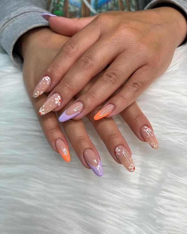 13. Pastel Split-Tone Almond Nails with Tiny Floral Details - spring almond nail ideas