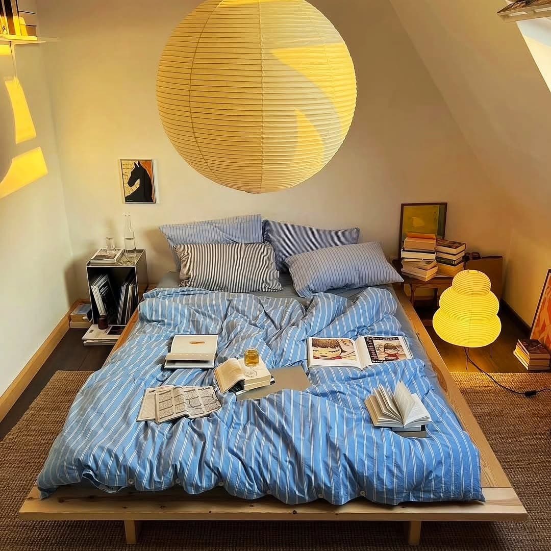 21. Blue Stripe Loft Bedroom With Soft Lantern Lighting - apartment bedroom ideas