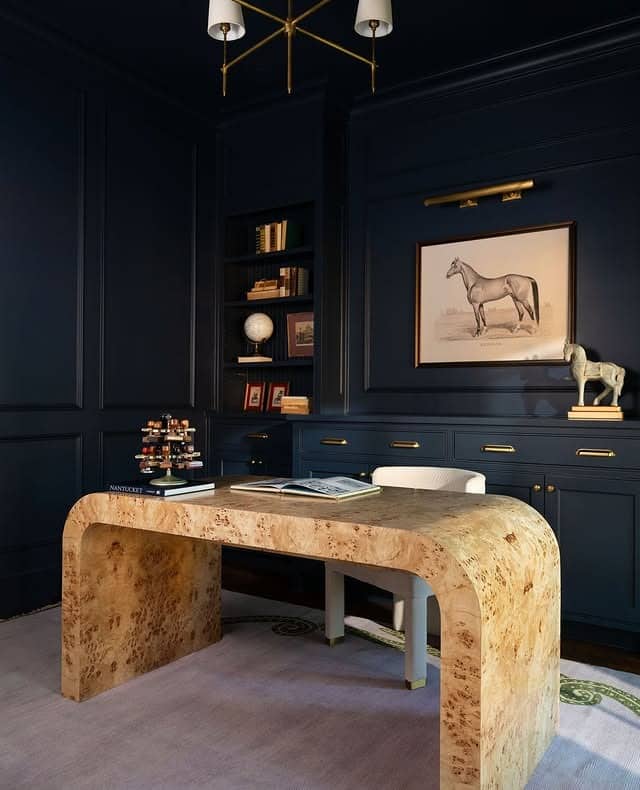 11. Deep Navy Walls with a Sculpted Burlwood Desk - paint colors for office ideas