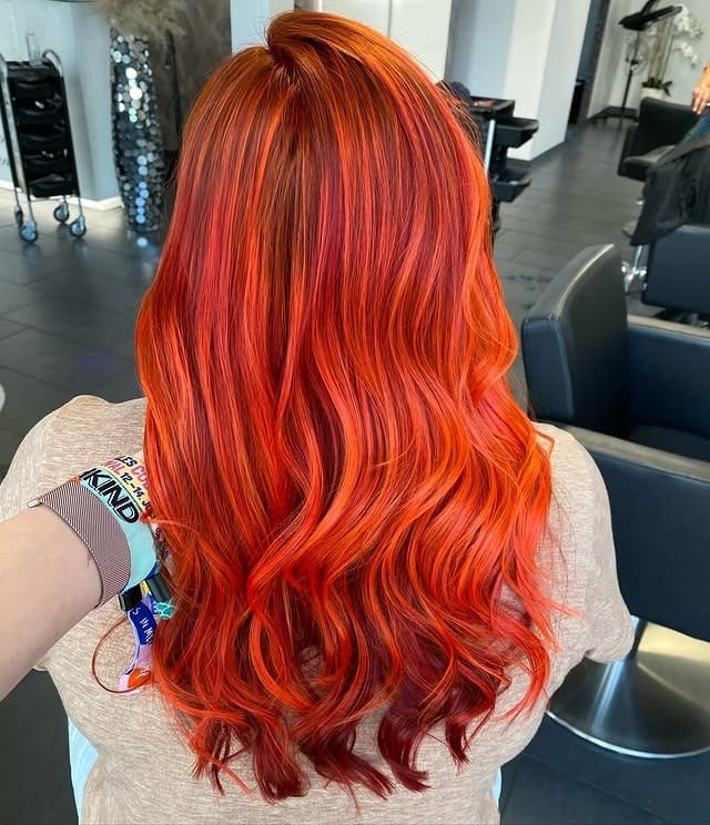 11. Radiant Red-Orange Waves with Dimensional Depth - Orange Hair Color