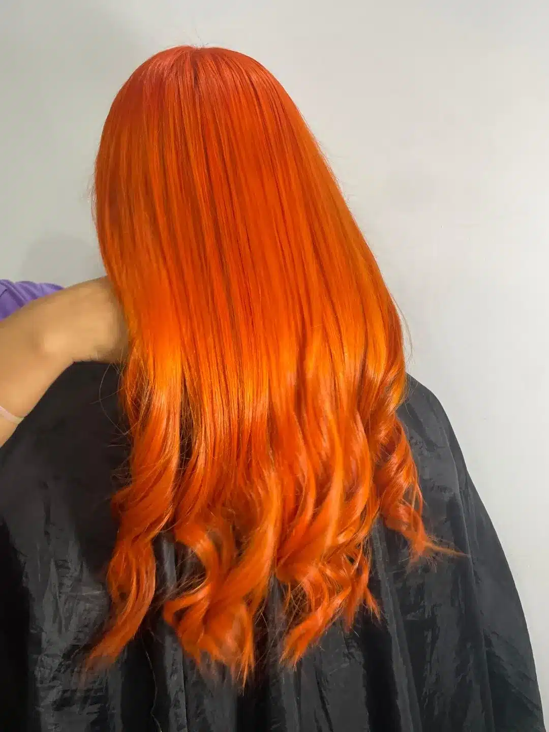 12. High-Gloss Tangerine Lengths with Curled Ends - Orange Hair Color