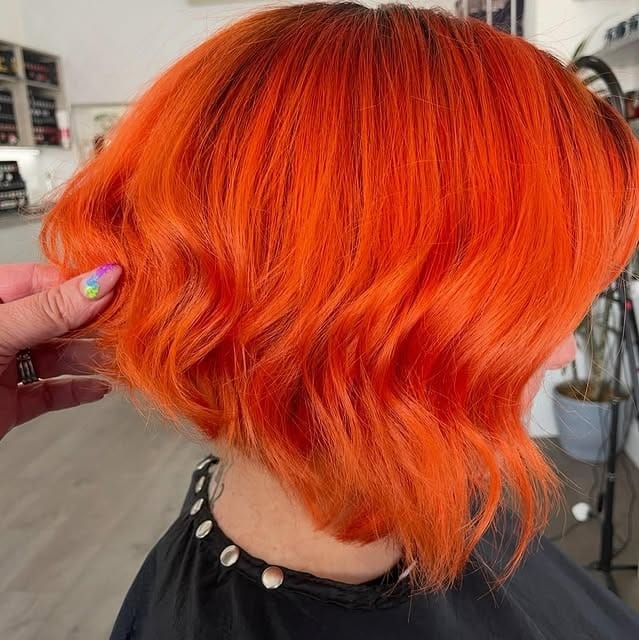 18. Vibrant Short Orange Waves - Orange Hair Color