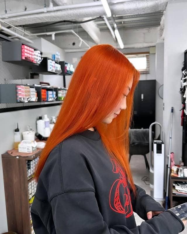 19. Sleek Long Copper-Orange Silhouette - Orange Hair Color
