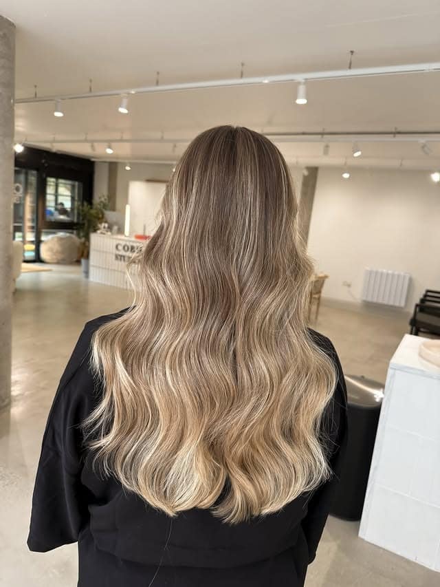 12. Natural Dark Blonde Waves with Subtle Lifted Ends - Dark Blonde Hair Color with Highlights