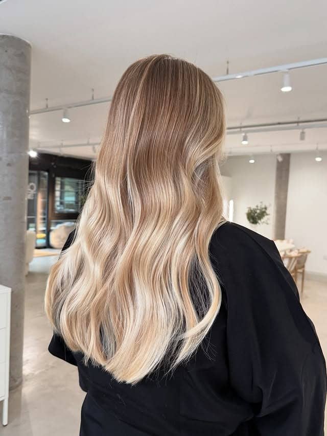 15. Polished Dark Blonde Glow with Brighter Mid-Lengths - Dark Blonde Hair Color with Highlights