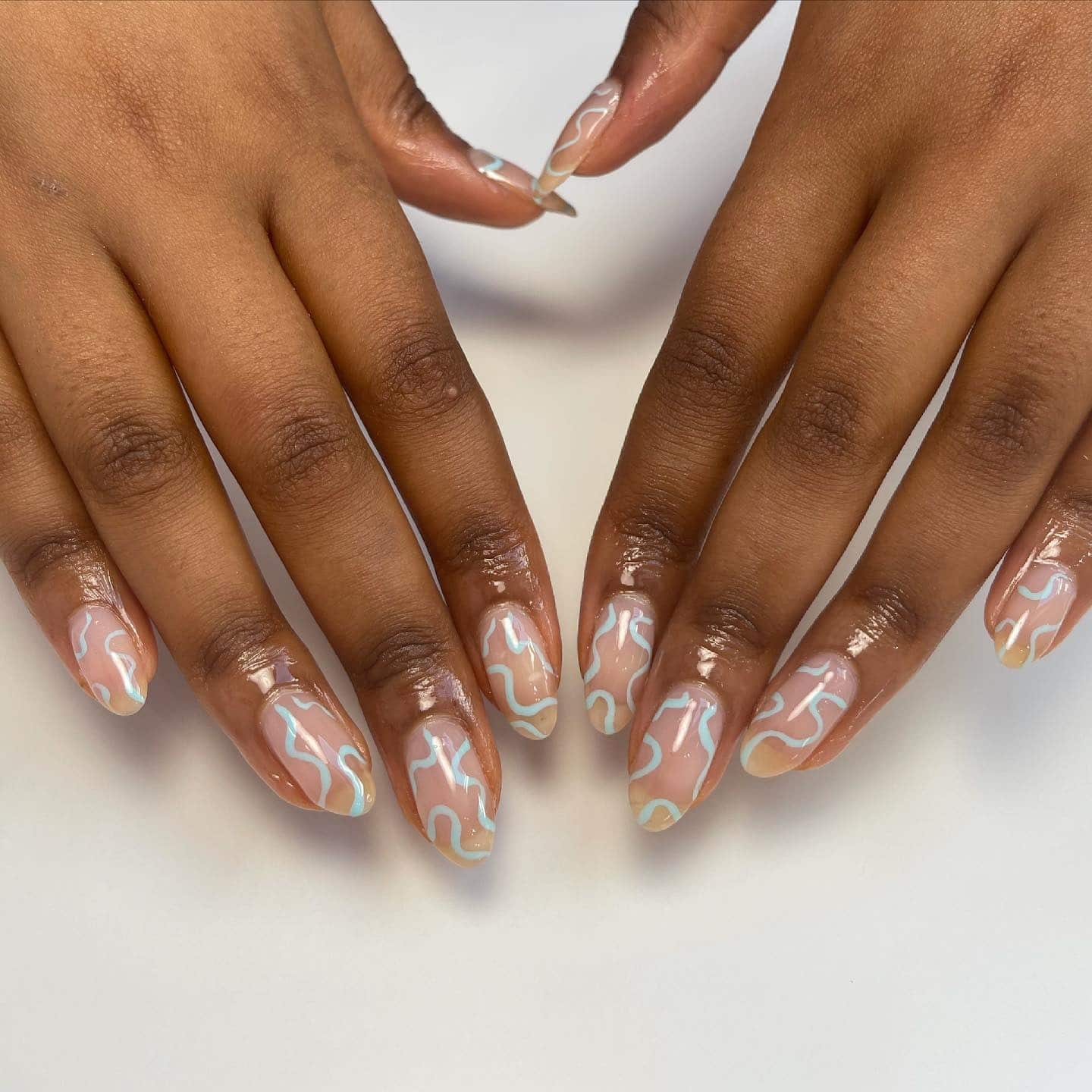 3. Pastel Aqua & Buttercream Squiggles on Nude Base - squiggly nail ideas
