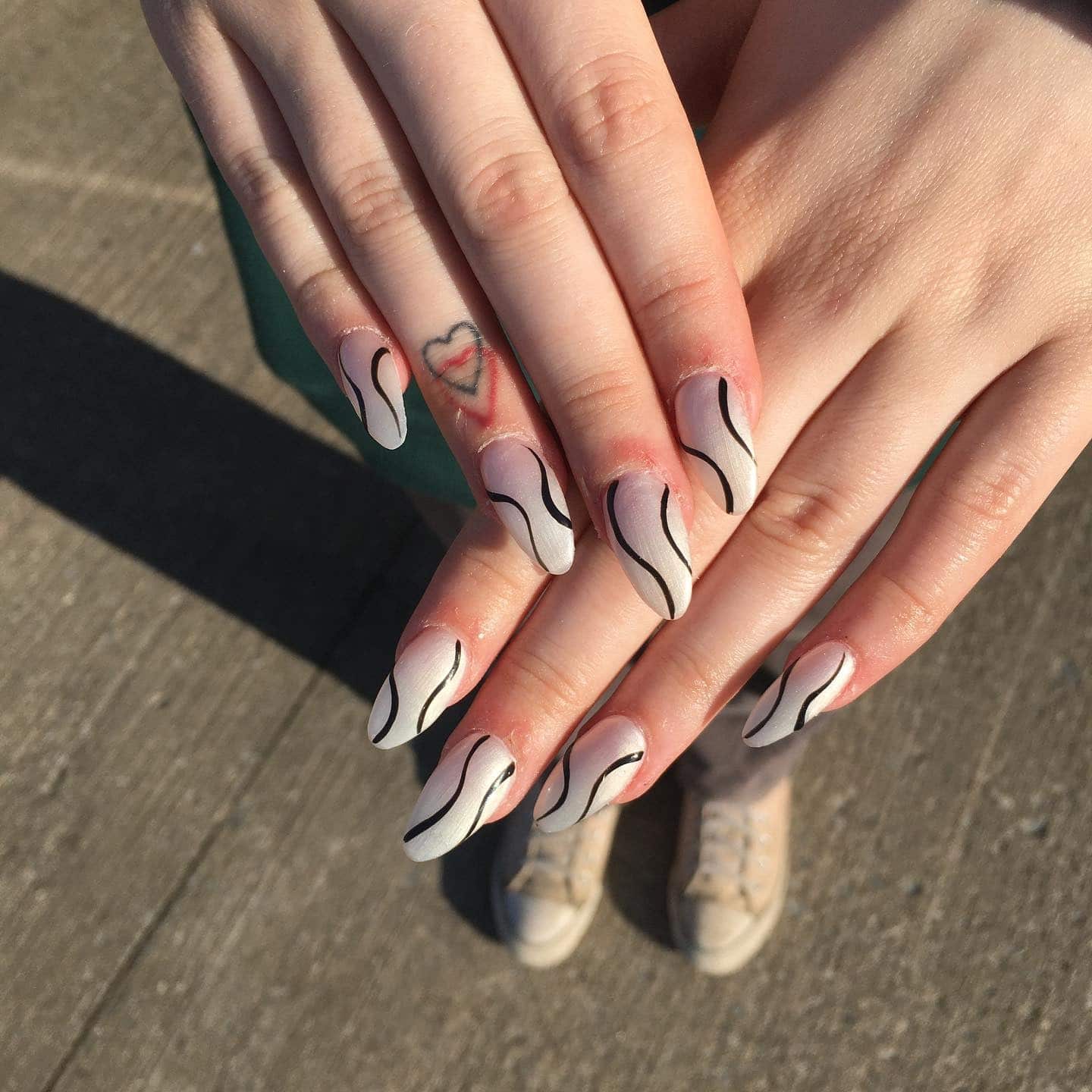 6. Matte Ivory Waves with Black Contrast Lines - squiggly nail ideas