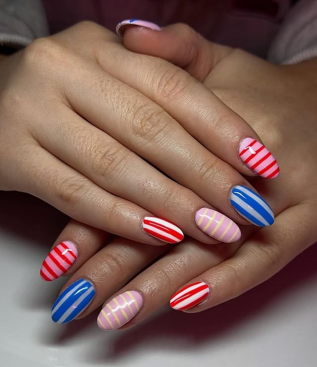 1. Bold Candy Stripe Mix in Red, Blue & Pastel Pink - striped nail ideas