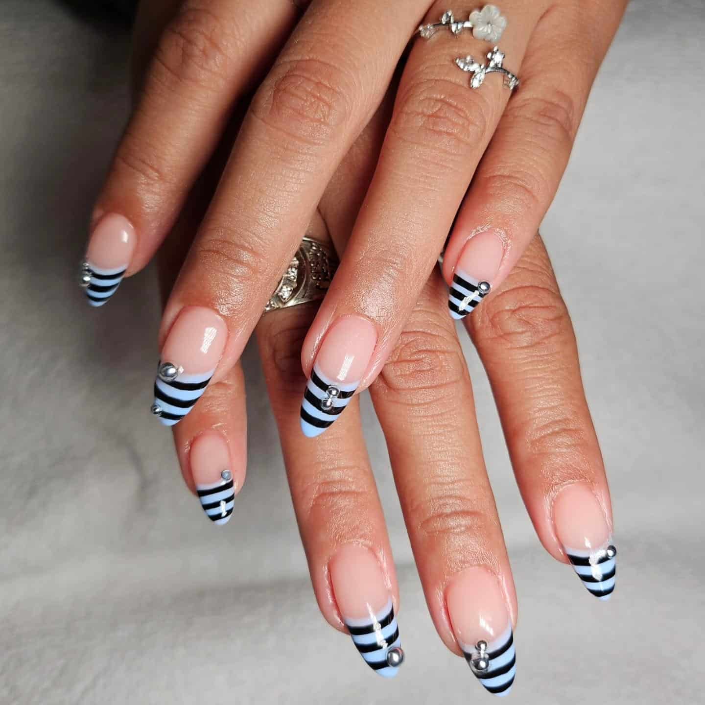 9. Blue & Black Striped French with Stud Accents - striped nail ideas