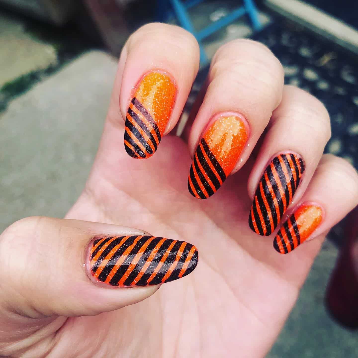 14. Glitter Orange & Black Diagonal Stripes - striped nail ideas