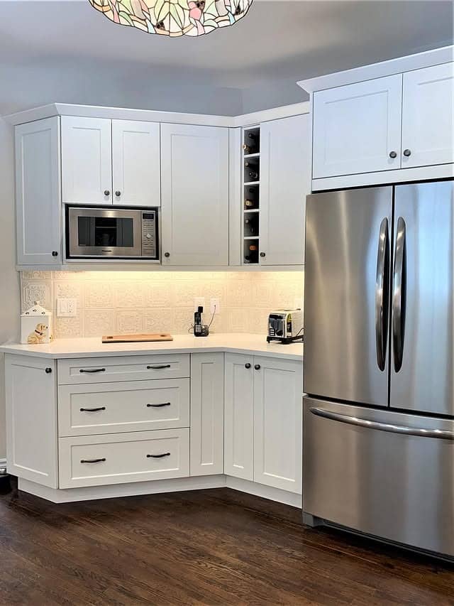 1. Soft White Shaker Kitchen with Subtle Textured Backsplash - kitchen backsplash ideas
