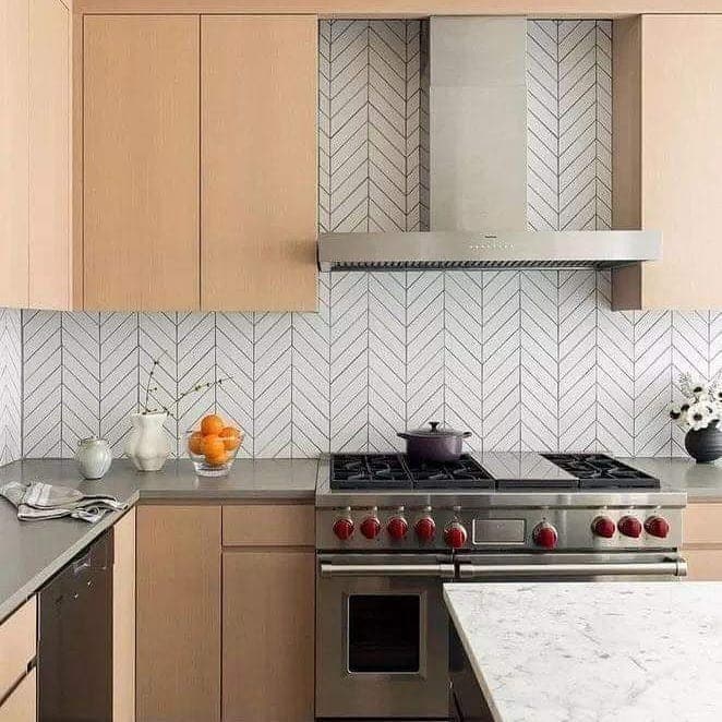 4. Soft Chevron Tile with Warm Wood Cabinets - kitchen backsplash ideas