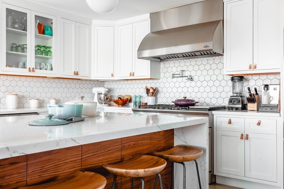 11. White Hexagon Tile with Warm Wood and Leather Accents - kitchen backsplash ideas