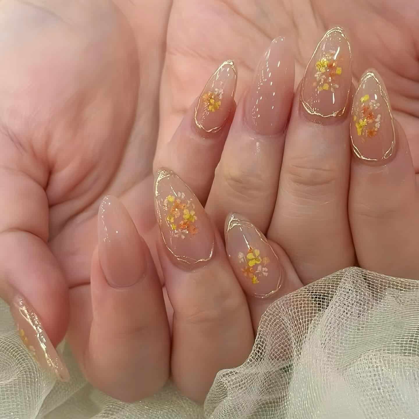 4. Gold-Outlined Floral Sheer Nails - subtle nail ideas