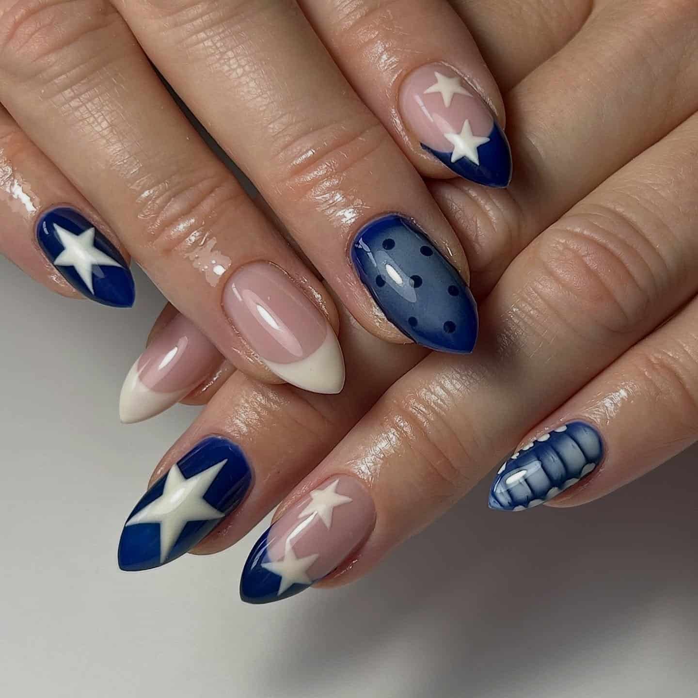 14. Navy Star Mix Nails on Almond Tips - subtle nail ideas