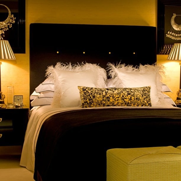 2. Feather-Trim Glamour in Gold and Black - black and yellow bedroom ideas