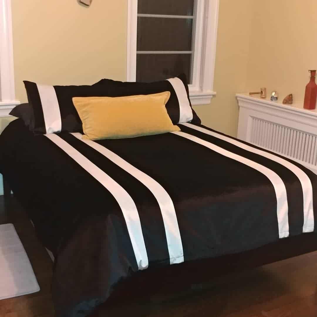 7. Streamlined Stripes with a Golden Touch - black and yellow bedroom ideas