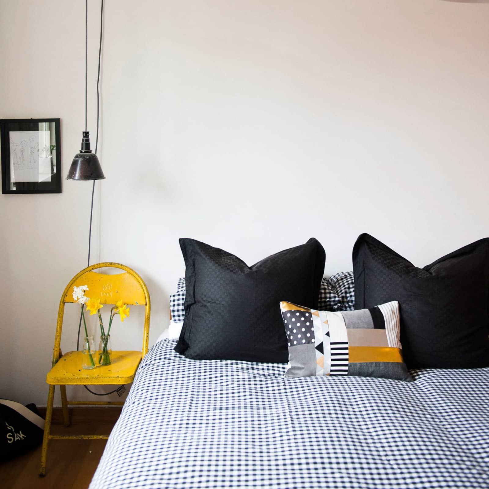 9. Casual Checkered Style with Artisan Accents - black and yellow bedroom ideas