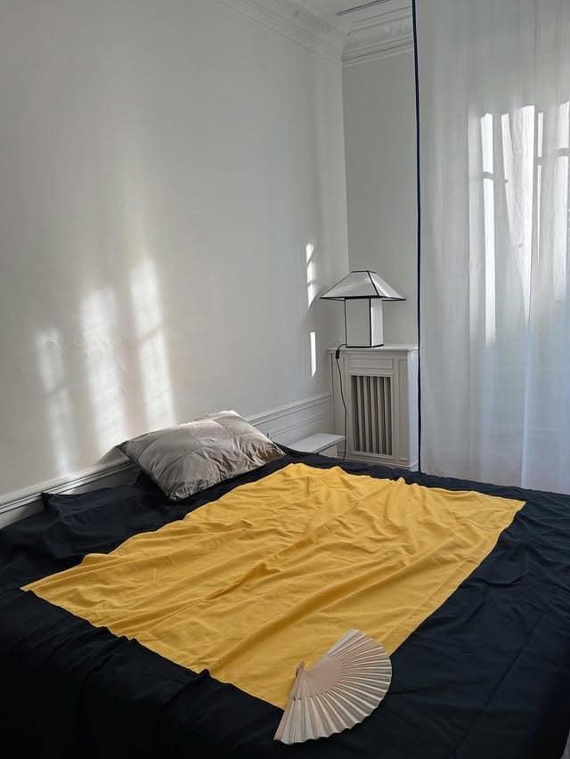 15. Minimal Bedding with a Bold Yellow Layer - black and yellow bedroom ideas