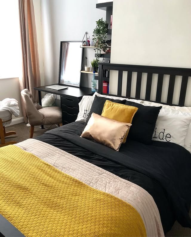 21. Soft Gold Layers in a Modern Black Setting - black and yellow bedroom ideas