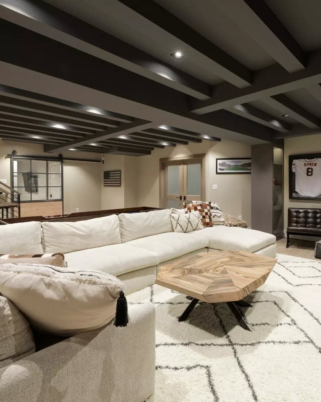 21. Contemporary Basement with Layered Wood and Cream Tones - basement living room ideas