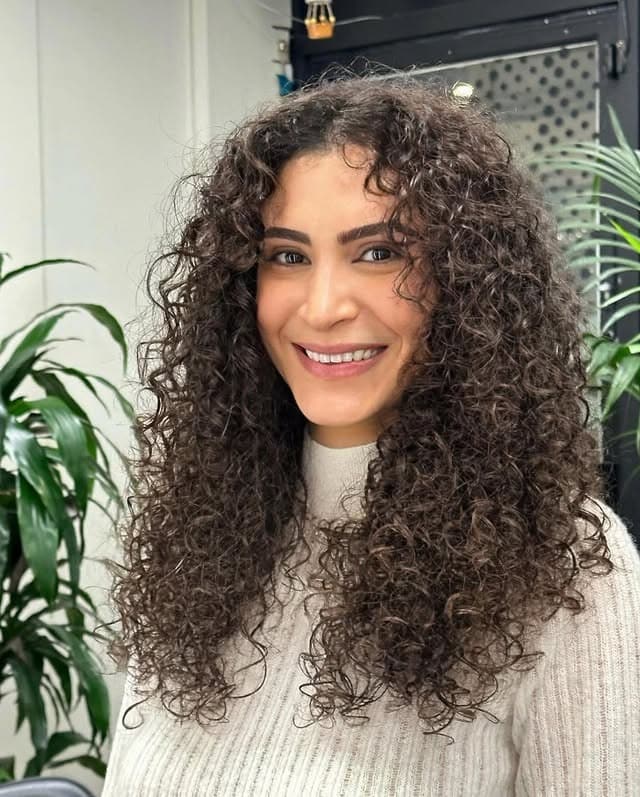 3. Long Curly Layers with Deep Espresso Shine - Layered Curly Hairstyles