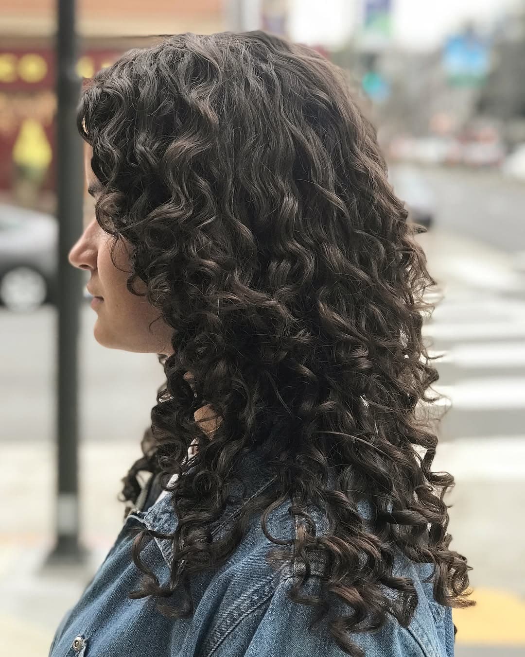 4. Soft Layered Spirals in Dark Neutral Brown - Layered Curly Hairstyles