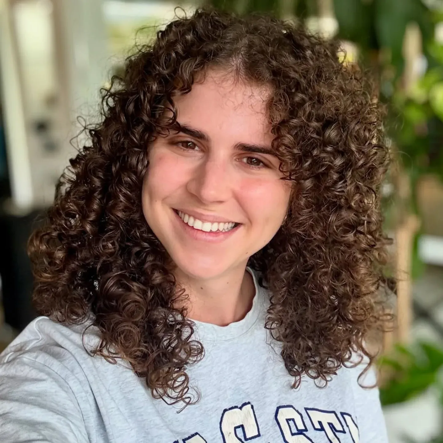 8. Voluminous Curly Layers with Light Caramel Accents - Layered Curly Hairstyles