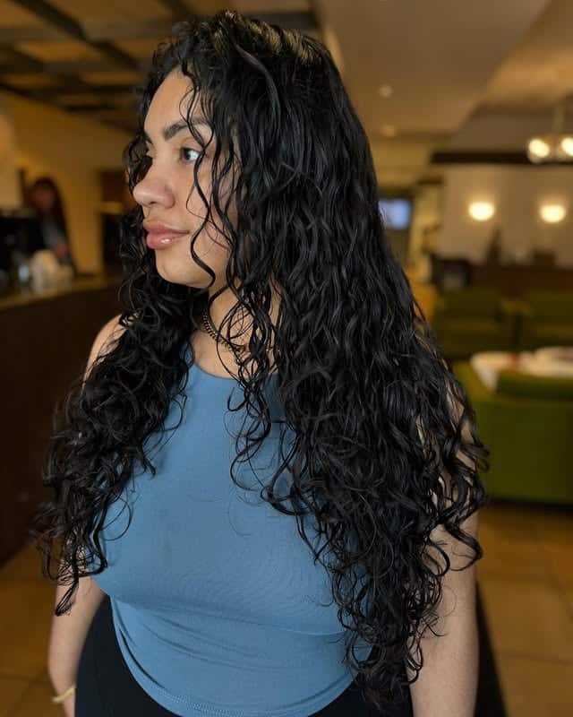 14. Ultra-Long Curly Layers in Deep Jet Black - Layered Curly Hairstyles