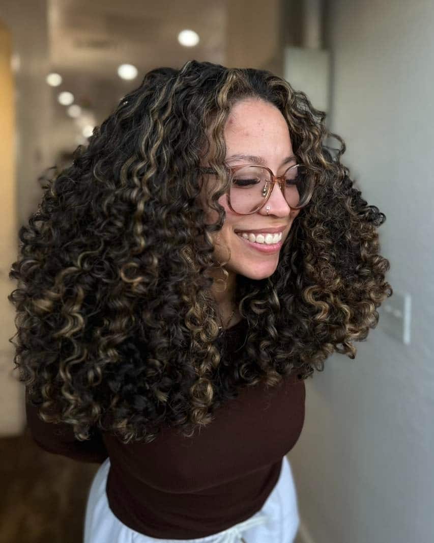 16. High-Volume Curly Layers with Honey Highlights - Layered Curly Hairstyles