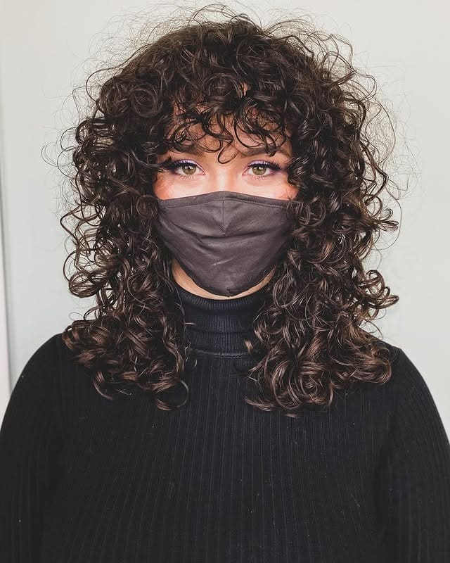 18. Curly Shag with Textured Fringe in Deep Brown - Layered Curly Hairstyles