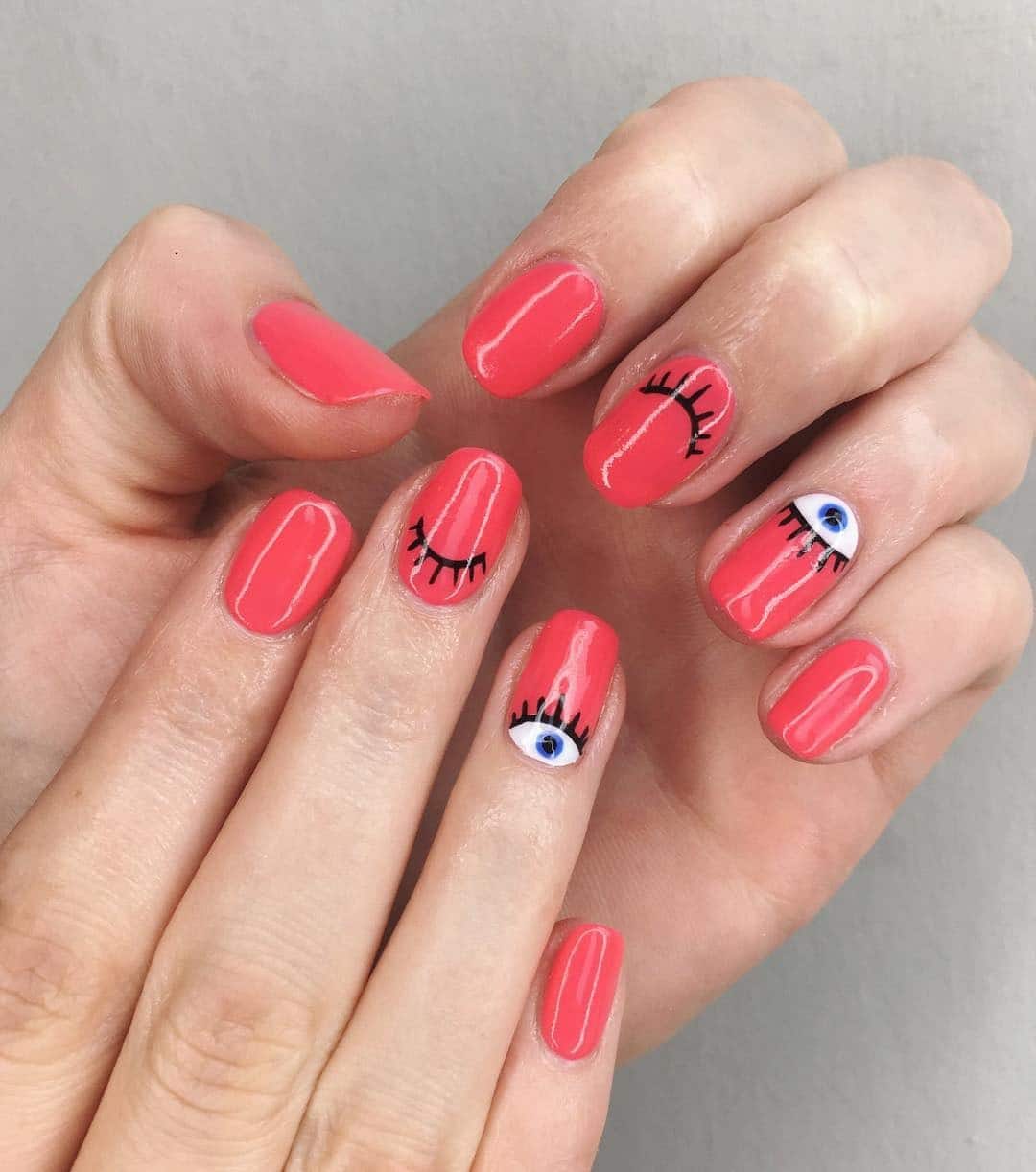 4. Coral Wink Art Nails - summer coral nail ideas