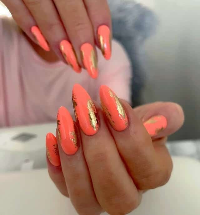 15. Coral Almond Nails with Gold Foil Touches - summer coral nail ideas